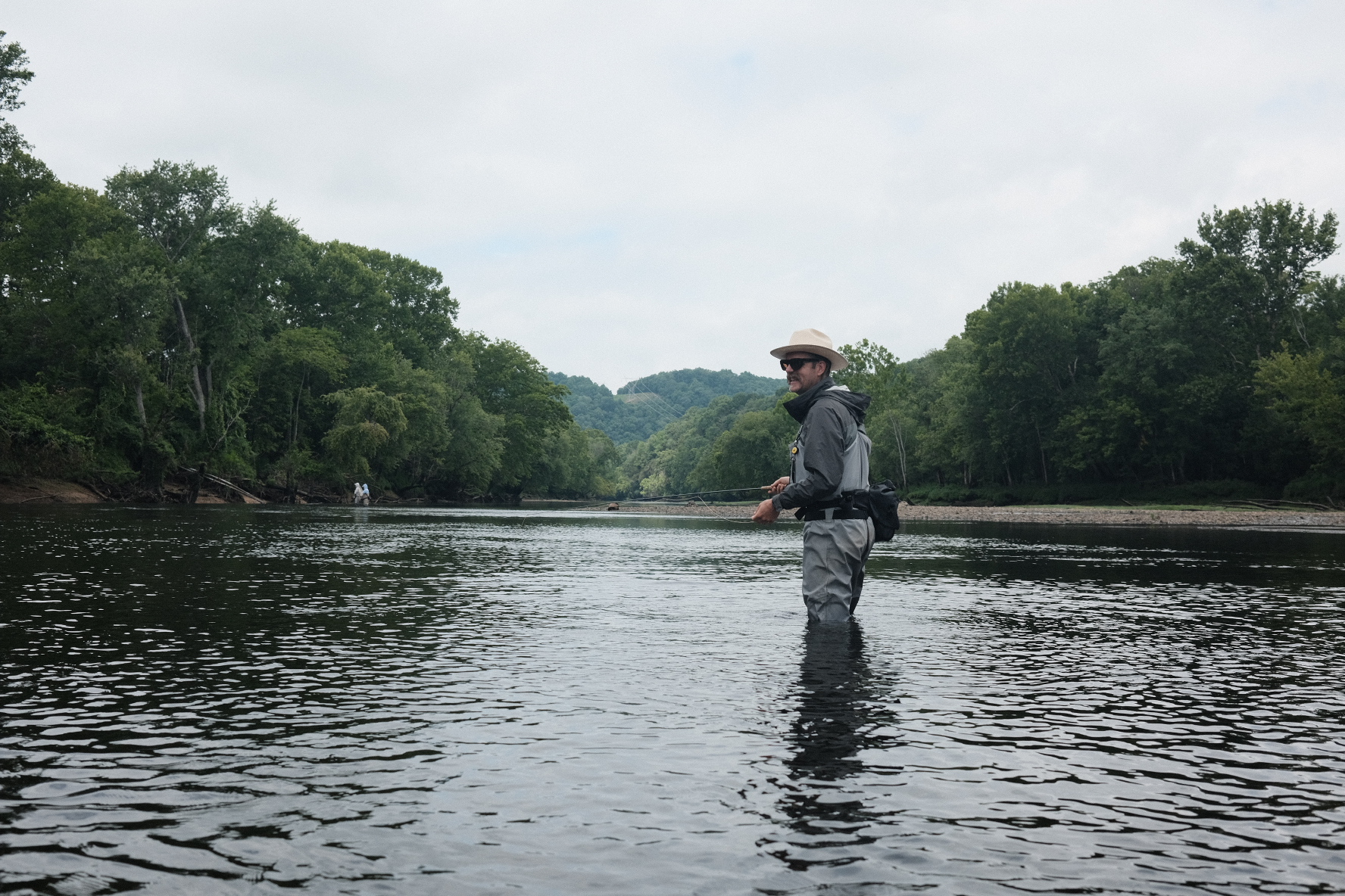 An angler fly-fishing in a river, from Can’d Aid’s Fishing with a Musician program